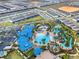 Aerial view of a luxury community with clubhouse, pool, and water features at 281 Jetty Way, Davenport, FL 33897