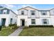 Inviting townhome with a gray brick walkway, well-kept landscaping, and a freshly painted exterior at 281 Jetty Way, Davenport, FL 33897