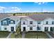 Attractive two-story townhomes featuring covered entries and manicured landscaping at 281 Jetty Way, Davenport, FL 33897