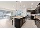 Spacious kitchen with an island, stainless steel appliances, and an open view of the living room at 281 Jetty Way, Davenport, FL 33897