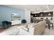 Open-concept living area with stylish furniture, a mounted TV, and seamless access to the kitchen at 281 Jetty Way, Davenport, FL 33897