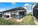 View of the pool and patio within the screened enclosure and backyard at 281 Jetty Way, Davenport, FL 33897