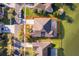 Birds eye view of backyard with screened in pool and lake, surrounded by lush greenery and a well-maintained neighborhood at 2864 Lafayette Trace Dr, St Cloud, FL 34772
