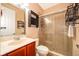 Bathroom featuring a vanity with storage, framed mirror, shower stall with glass door, and ceramic tile at 2864 Lafayette Trace Dr, St Cloud, FL 34772