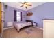 Cute bedroom with tile flooring, purple walls, a ceiling fan, and natural light from the window at 2864 Lafayette Trace Dr, St Cloud, FL 34772
