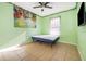 Bright bedroom with tile flooring, light green walls, a ceiling fan, and a window with natural light at 2864 Lafayette Trace Dr, St Cloud, FL 34772