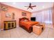 A cozy bedroom showcases a wooden bed frame, warm lighting, and an adjacent dresser at 2864 Lafayette Trace Dr, St Cloud, FL 34772