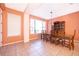Bright dining room with a large window, chandelier, and a classic wooden table at 2864 Lafayette Trace Dr, St Cloud, FL 34772