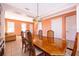 Spacious dining area with a classic chandelier, wooden table, and easy access to the kitchen at 2864 Lafayette Trace Dr, St Cloud, FL 34772