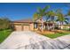 Single-story home boasting a two-car garage, beautiful landscaping, and a well-kept lawn at 2864 Lafayette Trace Dr, St Cloud, FL 34772