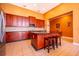 A well-lit kitchen with a large island, stainless steel appliances, and dark wood cabinetry at 2864 Lafayette Trace Dr, St Cloud, FL 34772
