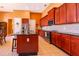 Bright kitchen features an island, stainless steel appliances, and dark wood cabinets at 2864 Lafayette Trace Dr, St Cloud, FL 34772