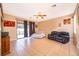 Bright and open living room with tile flooring, ceiling fan, with access to screened patio through sliding glass doors at 2864 Lafayette Trace Dr, St Cloud, FL 34772