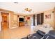 Living room with tile floors, neutral paint, ceiling fan, entertainment center, and access to screened patio at 2864 Lafayette Trace Dr, St Cloud, FL 34772