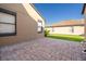 Paver patio area with a small patch of grass, exterior windows, and a view of the adjacent property at 2864 Lafayette Trace Dr, St Cloud, FL 34772