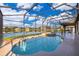 Beautiful in-ground screened-in pool with a hot tub offering stunning water views for ultimate relaxation and enjoyment at 2864 Lafayette Trace Dr, St Cloud, FL 34772