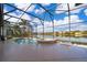 Inviting screened-in pool and hot tub overlooking a serene lake, providing a perfect oasis for relaxation and recreation at 2864 Lafayette Trace Dr, St Cloud, FL 34772