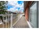 Balcony features wood flooring, a white railing, and a brick exterior at 3060 George Mason Ave # 12 D, Winter Park, FL 32792