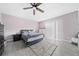 This bedroom features stylish gray tile floors, a ceiling fan, a window, and a closet at 3060 George Mason Ave # 12 D, Winter Park, FL 32792