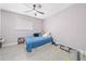 Cozy bedroom with tile flooring, a ceiling fan, and bright window at 3060 George Mason Ave # 12 D, Winter Park, FL 32792