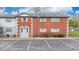 Charming brick townhouse featuring light blue shutters and a dedicated parking area at 3060 George Mason Ave # 12, Winter Park, FL 32792