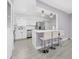 Modern kitchen featuring sleek white cabinetry and a stylish island with seating at 3060 George Mason Ave # 12 D, Winter Park, FL 32792