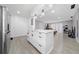 Open kitchen featuring white cabinets, a peninsula, and easy access to the living area at 3060 George Mason Ave # 12 D, Winter Park, FL 32792