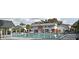 Community pool is surrounded by lush greenery with some multi-story buildings in the background at 3060 George Mason Ave # 12 D, Winter Park, FL 32792