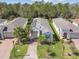 Aerial view of a well maintained property with lush landscaping and a welcoming brick driveway at 309 Vestrella Dr, Poinciana, FL 34759