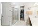 Bathroom showcasing tiled shower with glass door and a view into the walk-in closet at 309 Vestrella Dr, Poinciana, FL 34759