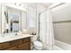 Well-lit bathroom features single vanity, modern fixtures, and combination tub and shower with curtain at 309 Vestrella Dr, Poinciana, FL 34759