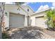 Spacious home with a three car garage, brick driveway, and well maintained yard at 309 Vestrella Dr, Poinciana, FL 34759