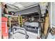 View of garage showing a golf cart and storage shelves, maximizing space for vehicles and organization at 309 Vestrella Dr, Poinciana, FL 34759