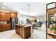 Open-concept kitchen with island, stainless steel appliances, granite counters, and a seamless flow to the living area at 309 Vestrella Dr, Poinciana, FL 34759