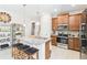 Charming kitchen with granite island, stainless steel appliances, and ample cabinetry, perfect for culinary enthusiasts at 309 Vestrella Dr, Poinciana, FL 34759