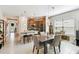 Bright and airy kitchen flows to dining area, featuring a large island with seating and modern stainless steel appliances at 309 Vestrella Dr, Poinciana, FL 34759