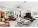 Expansive living room boasting tile floors, a ceiling fan, and glass doors to the lanai at 309 Vestrella Dr, Poinciana, FL 34759