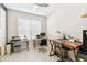 Home office space with two desks, a ceiling fan, and bright natural light from a window at 309 Vestrella Dr, Poinciana, FL 34759