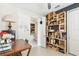 Office space features a large desk, custom shelving, and a view into an adjacent room at 309 Vestrella Dr, Poinciana, FL 34759