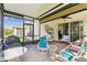 Relaxing screened patio featuring brick floors, ceiling fan, and comfortable seating, creating an inviting outdoor space at 309 Vestrella Dr, Poinciana, FL 34759