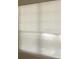 Close up of a window covered with white horizontal blinds at 3712 Castle Pines Ln # 4126, Orlando, FL 32839
