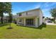 Relax on the covered patio in the spacious backyard of this home in a vibrant community at 3725 Deer Ridge Dr, Mount Dora, FL 32757