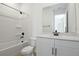 Bathroom with white cabinets, black hardware, shower and bath at 3725 Deer Ridge Dr, Mount Dora, FL 32757