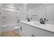 Bright bathroom featuring white cabinets, black hardware, shower and bath at 3725 Deer Ridge Dr, Mount Dora, FL 32757