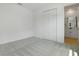 Bright bedroom featuring gray carpet, a closet, and an ensuite bathroom at 3725 Deer Ridge Dr, Mount Dora, FL 32757