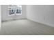 Bright bedroom featuring gray carpet and a large window at 3725 Deer Ridge Dr, Mount Dora, FL 32757
