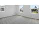 Bright bedroom featuring gray carpet and large windows at 3725 Deer Ridge Dr, Mount Dora, FL 32757