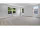 Large bedroom featuring gray carpet and many windows at 3725 Deer Ridge Dr, Mount Dora, FL 32757