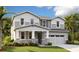 Charming two-story home with stone accents, a covered porch, and a two-car garage at 3725 Deer Ridge Dr, Mount Dora, FL 32757