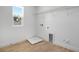 Bright laundry room with wood-look tile floor and a window at 3725 Deer Ridge Dr, Mount Dora, FL 32757